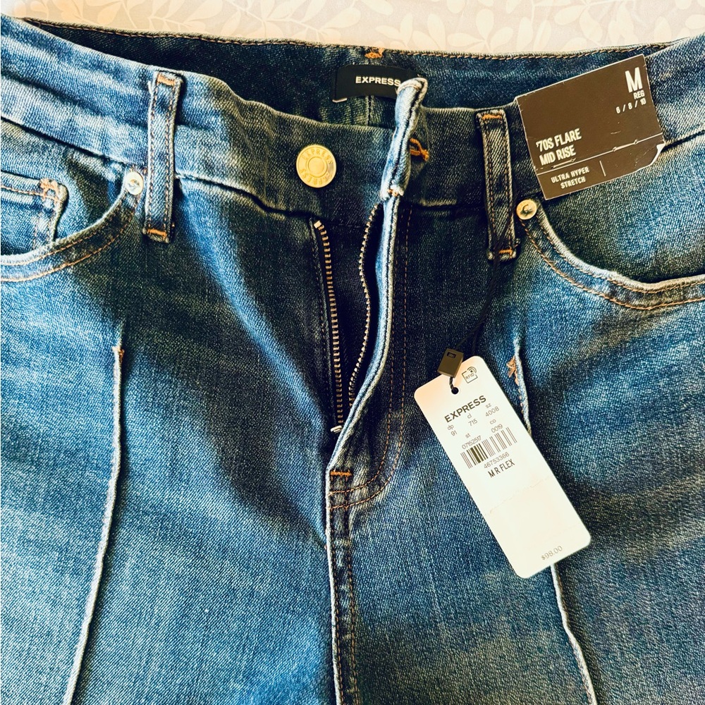 Express Mid Rise Wash Pintuck Raw Hem FlexX ‘70s Flare Jeans